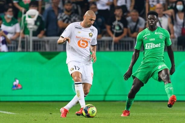 Burak Yilmaz of Lille passes the ball during the Ligue 1 Uber Eats match between Saint Etienne and Lille at Stade Geoffroy-Guichard on August 21,...