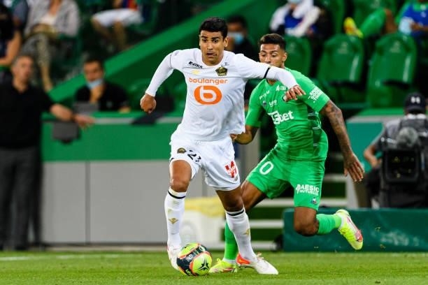 Benjamin Andre of Lille is chased by Denis Bouanga of Saint-Étienne during the Ligue 1 Uber Eats match between Saint Etienne and Lille at Stade...