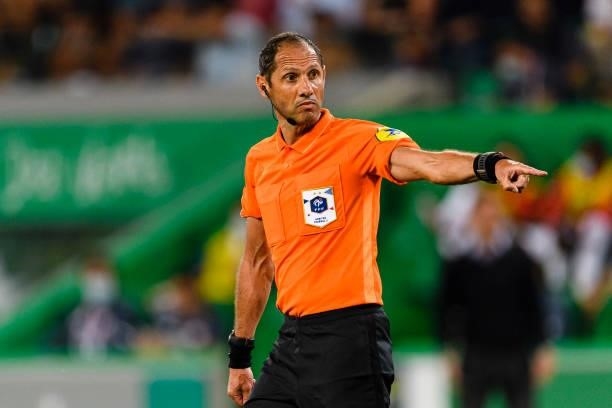 Referee Mikael Lesage gestures during the Ligue 1 Uber Eats match between Saint Etienne and Lille at Stade Geoffroy-Guichard on August 21, 2021 in...