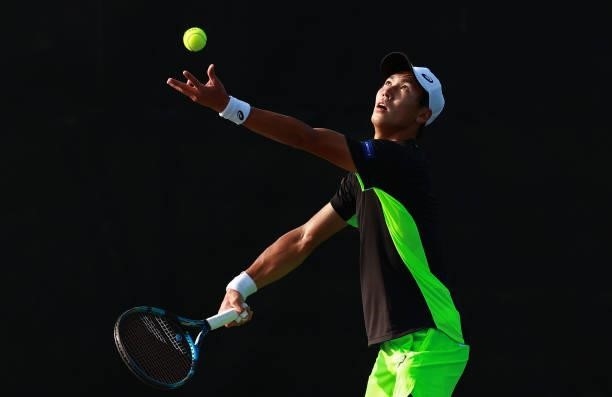 Yosuke Watanuki of Japan returns a shot to Jaume Munar of Spain on Day 3 of the Winston-Salem Open at Wake Forest Tennis Complex on August 23, 2021...