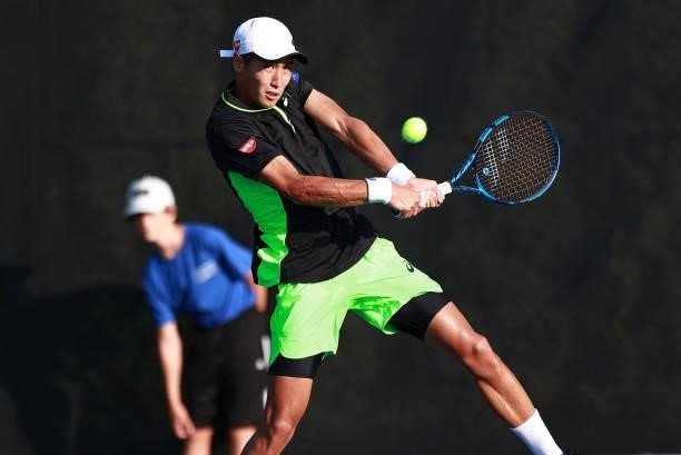 Yosuke Watanuki of Japan returns a shot to Jaume Munar of Spain on Day 3 of the Winston-Salem Open at Wake Forest Tennis Complex on August 23, 2021...