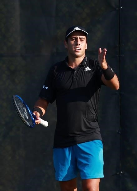 Jaume Munar of Spain questions the chair umpire after a call during his match against Yosuke Watanuki of Japan on Day 3 of the Winston-Salem Open at...