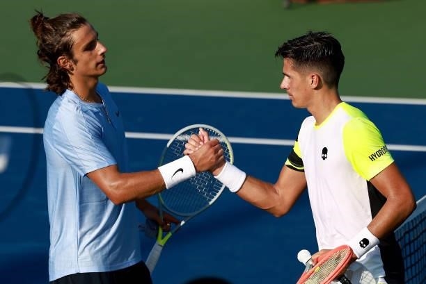 Federico Coria of Argentina and Lorenzo Musetti of Italy meet at the net after their match on Day 3 of the Winston-Salem Open at Wake Forest Tennis...