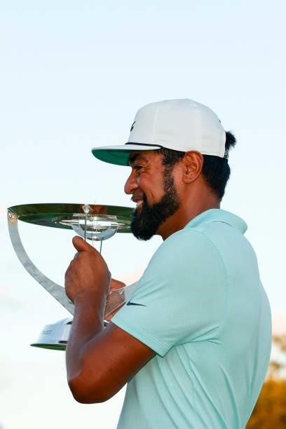 Tony Finau of the United States celebrates with the trophy after winning in a playoff during the final round of THE NORTHERN TRUST, the first event...