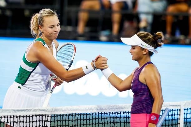 Anett Kontaveit of Estonia shakes hands with Lauren Davis of the United States after winning her match on Day 2 of the Cleveland Championships at...