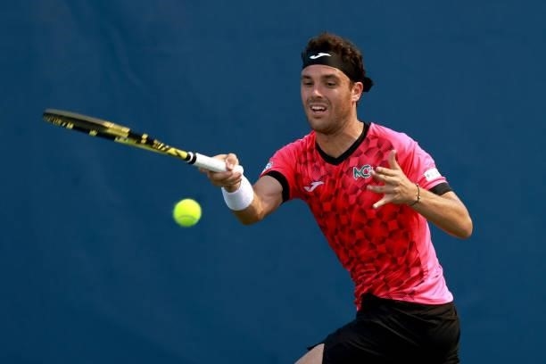 Marco Cecchinato of Italy returns a shot to Dominik Koepfer of Germany on Day 3 of the Winston-Salem Open at Wake Forest Tennis Complex on August 23,...