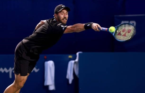 Steve Johnson returns a shot to Alexei Popyrin of Australia on Day 3 of the Winston-Salem Open at Wake Forest Tennis Complex on August 23, 2021 in...