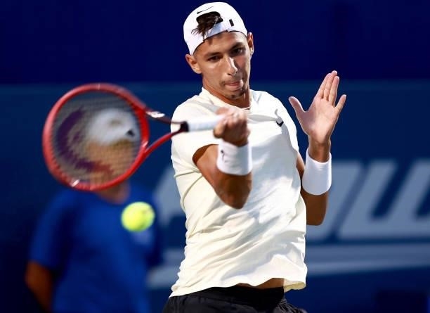 Alexei Popyrin of Australia returns a shot to Steve Johnson on Day 3 of the Winston-Salem Open at Wake Forest Tennis Complex on August 23, 2021 in...