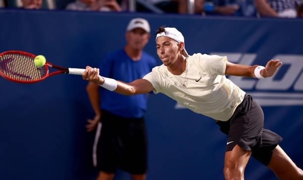 Alexei Popyrin of Australia returns a shot to Steve Johnson on Day 3 of the Winston-Salem Open at Wake Forest Tennis Complex on August 23, 2021 in...