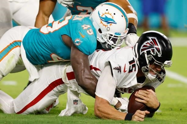 Sam Eguavoen of the Miami Dolphins sacks Feleipe Franks of the Atlanta Falcons during a preseason game at Hard Rock Stadium on August 21, 2021 in...