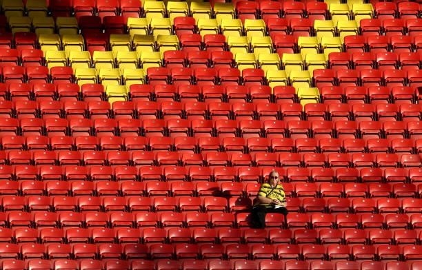 Lone Watford fan sitting in the stands before the Carabao Cup second round match between Watford and Crystal Palace at Vicarage Road Stadium on...