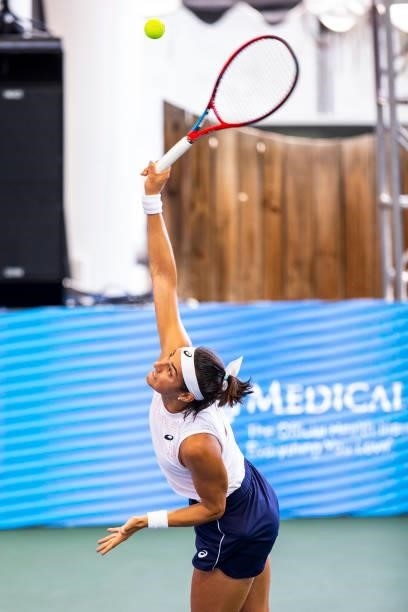 Caroline Garcia of France serves to Catherine Harrison of USA during the second set of their match at Jacobs Pavilion on August 23, 2021 in...