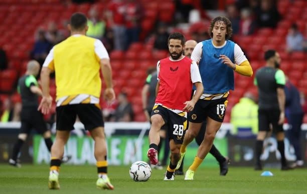 Joao Moutinho of Wolverhampton Wanderers passes the ball under pressure from Fabio Silva as they warm up prior to the Carabao Cup Second Round match...