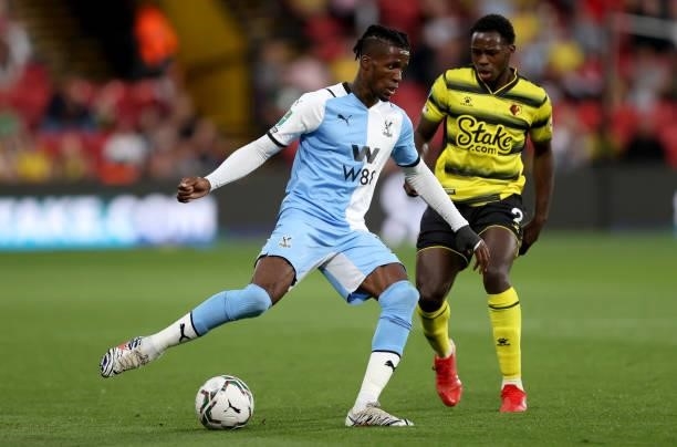 Wilfried Zaha of Crystal Palace is challenged by Jeremy Ngakia of Watford during the Carabao Cup second round match between Watford and Crystal...