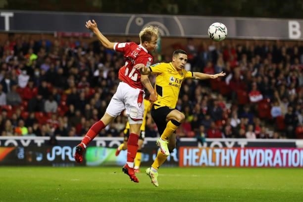 Daniel Podence of Wolverhampton Wanderers and Fin Back of Nottingham Forest compete for a header during the Carabao Cup Second Round match between...