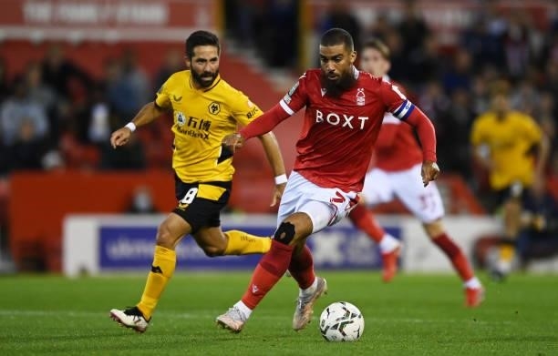 Lewis Grabban of Nottingham Forest runs with the ball under pressure from Joao Moutinho of Wolverhampton Wanderers during the Carabao Cup Second...