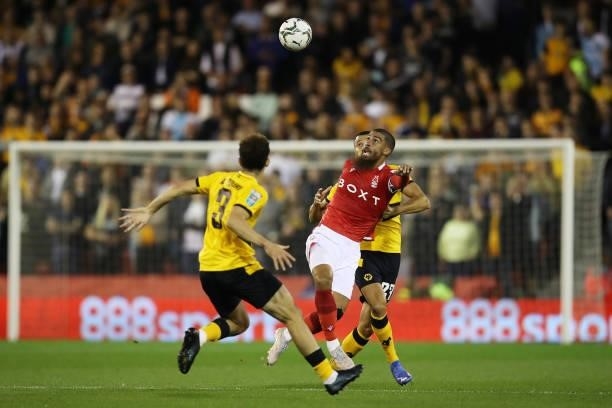 Lewis Grabban of Nottingham Forest battles for possession with Romain Saiss of Wolverhampton Wanderers during the Carabao Cup Second Round match...