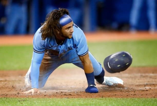 Bo Bichette of the Toronto Blue Jays scores a run on a double by Vladimir Guerrero Jr. #27 in the sixth inning during a MLB game against the Chicago...