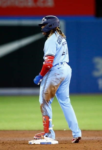 Vladimir Guerrero Jr. #27 of the Toronto Blue Jays reacts after Bo Bichette scores a run on a double in the sixth inning during a MLB game against...