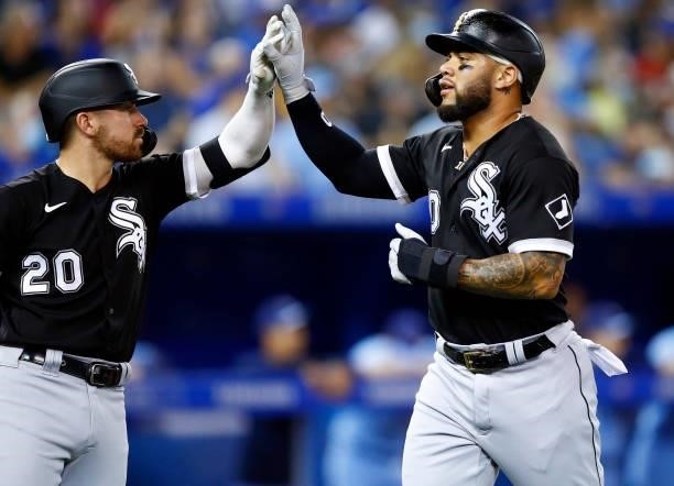 Yoan Moncada of the Chicago White Sox celebrates with Danny Mendick after scoring a run on a single by Andrew Vaughn in the sixth inning during a MLB...
