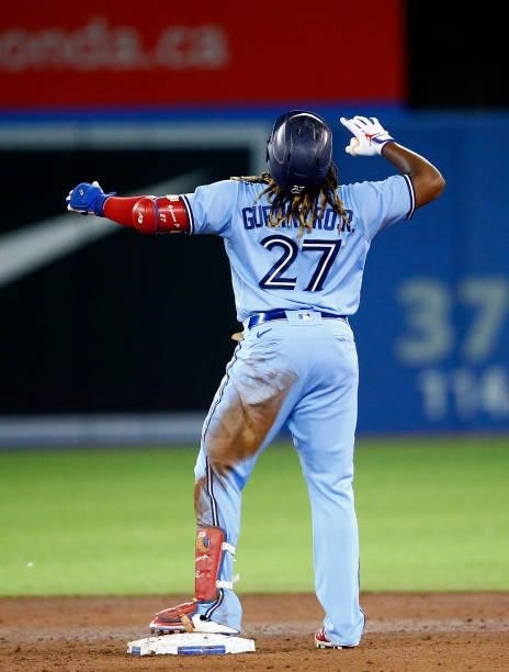 Vladimir Guerrero Jr. #27 of the Toronto Blue Jays reacts after Bo Bichette scores a run on a double in the sixth inning during a MLB game against...