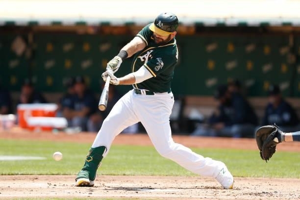 Mitch Moreland of the Oakland Athletics hits an RBI single in the bottom of the first inning against the Seattle Mariners at RingCentral Coliseum on...