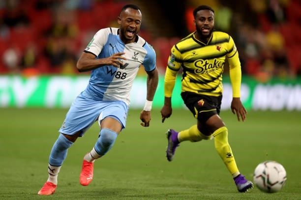 Jordan Ayew of Crystal Palace is challenged by Danny Rose of Watford during the Carabao Cup second round match between Watford and Crystal Palace at...