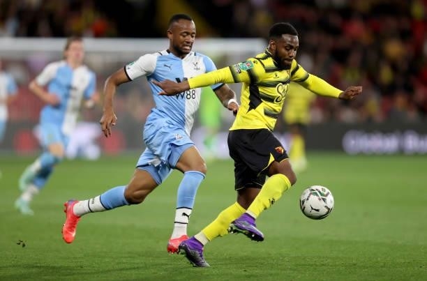 Danny Rose of Watford is challenged by Jordan Ayew of Crystal Palace during the Carabao Cup second round match between Watford and Crystal Palace at...