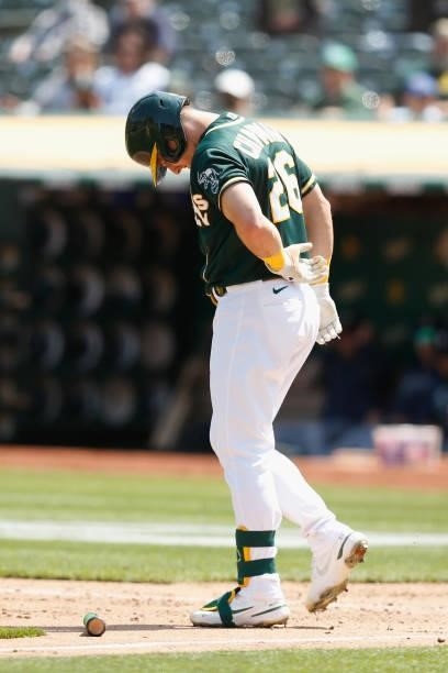 Matt Chapman of the Oakland Athletics reacts after being hit by a pitch in the bottom of the fourth inning against the Seattle Mariners at...