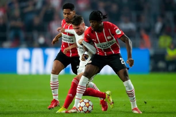 Rafa Silva of Benfica and Noni Madueke of PSV battle for possession during the UEFA Champions League Play-Offs Leg Two match between PSV and Benfica...