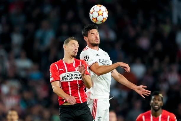 Olivier Boscagli of PSV competes for the headed ball with Roman Yaremchuk of Benfica during the UEFA Champions League Play-Offs Leg Two match between...