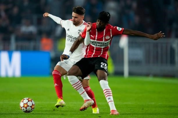 Rafa Silva of Benfica and Noni Madueke of PSV battle for possession during the UEFA Champions League Play-Offs Leg Two match between PSV and Benfica...