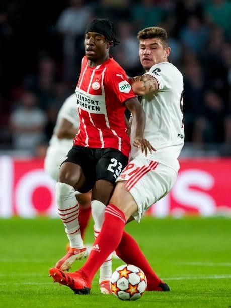Noni Madueke of PSV competes for the ball against Morato of Benfica during the UEFA Champions League Play-Offs Leg Two match between PSV and Benfica...