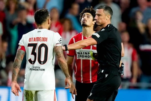 Nicolas Otamendi of Benfica, Referee Slavko Vincic and Andre Ramalho of PSV during the UEFA Champions League Play-Offs Leg Two match between PSV and...