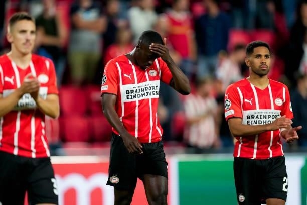Jordan Teze of PSV and Phillipp Mwene of PSV look dejected during the UEFA Champions League Play-Offs Leg Two match between PSV and Benfica at...