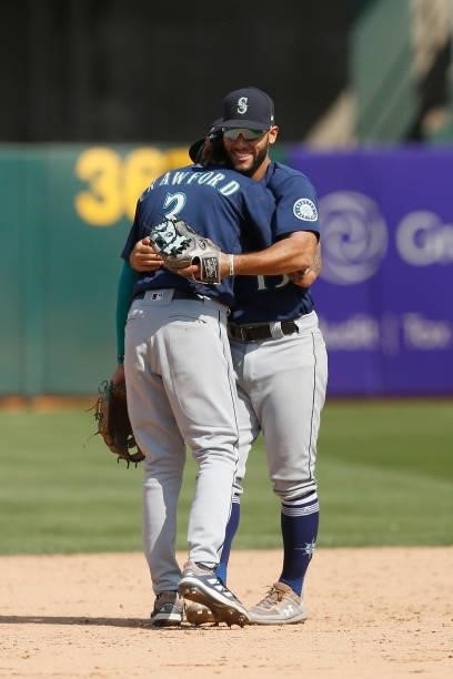 Seattle Mariners players J.P. Crawford and Abraham Toro celebrate after a win against the Oakland Athletics at RingCentral Coliseum on August 24,...