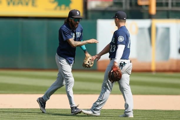 Seattle Mariners players J.P. Crawford and Ty France celebrate after a win against the Oakland Athletics at RingCentral Coliseum on August 24, 2021...