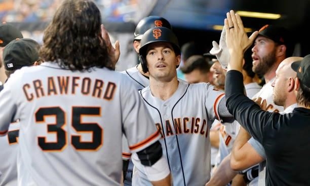 Mike Yastrzemski of the San Francisco Giants celebrates his second inning two run home run against the New York Mets with his teammates in the dugout...