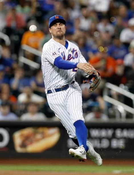 Davis of the New York Mets attempts to throw out LaMonte Wade Jr. Of the San Francisco Giants during the eighth inning at Citi Field on August 24,...