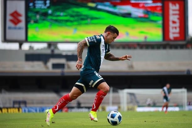 Christian Tabo of Puebla drives the ball during the 6th round match between Pumas UNAM and Puebla as part of the Torneo Grita Mexico A21 Liga MX at...