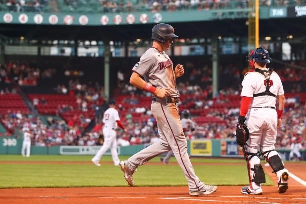 Max Kepler of the Minnesota Twins score I the first inning of a game against teh Boston Red Sox at Fenway Park on August 24, 2021 in Boston,...