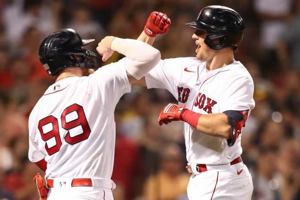 Hunter Renfroe of the Boston Red Sox reacts with Alex Verdugo of the Boston Red Sox after hitting a solo home run in the fifth inning of a game...