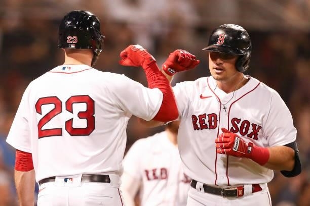 Hunter Renfroe of the Boston Red Sox reacts with Travis Shaw of the Boston Red Sox after hitting a solo home run in the fifth inning of a game...