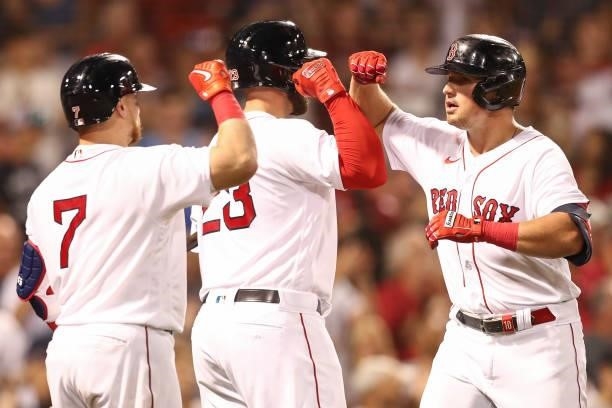 Hunter Renfroe of the Boston Red Sox high fives Travis Shaw of the Boston Red Sox after hitting a three-run home run in the fourth inning of a game...