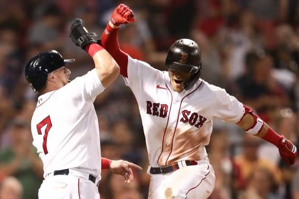 Enrique Hernandez of the Boston Red Sox reacts with Christian Vazquez of the Boston Red Sox after hitting a two-run home run in the eighth inning of...