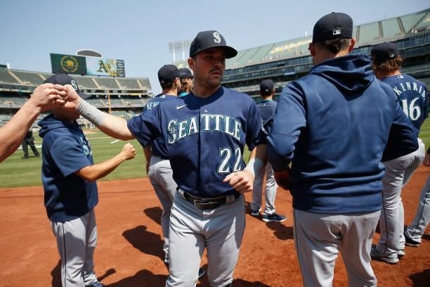 Luis Torrens of the Seattle Mariners gathers with teammates before the game against the Oakland Athletics at RingCentral Coliseum on August 24, 2021...