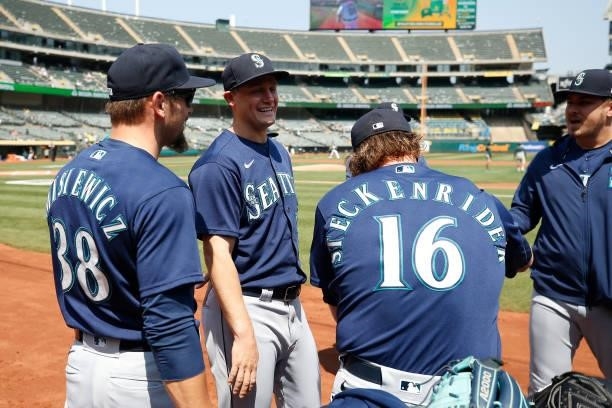 Paul Sewald of the Seattle Mariners chats with teammates before the game against the Oakland Athletics at RingCentral Coliseum on August 24, 2021 in...