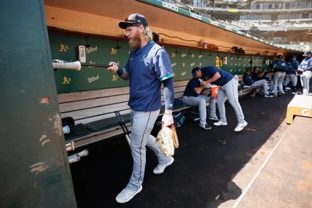 Jake Fraley of the Seattle Mariners puts his bats away in the dugout before the game against the Oakland Athletics at RingCentral Coliseum on August...