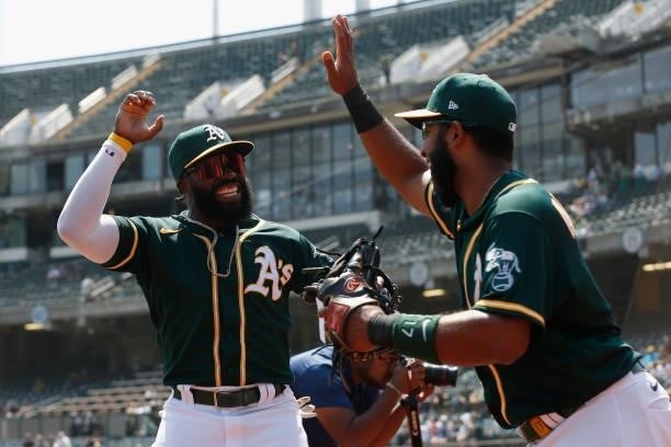 Josh Harrison and Elvis Andrus of the Oakland Athletics leave the dugout before the game against the Seattle Mariners at RingCentral Coliseum on...