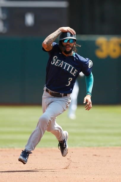 Base runner J.P. Crawford of the Seattle Mariners rounds second base against the Oakland Athletics at RingCentral Coliseum on August 24, 2021 in...